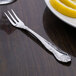 Oneida Rosewood stainless steel fork with a lemon slice on the table.