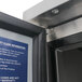 The interior of a food truck with a close-up of the Turbo Air MUF-60-N door, which has a sign that says cleanliness is important.