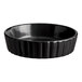 A black round Acopa Keystone porcelain dish with a ribbed rim.