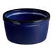A small, round, blue porcelain ramekin with a black rim.