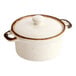 An 8 oz. vanilla bean porcelain mini casserole dish with a lid and two handles.