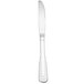A Oneida stainless steel dinner knife with a white handle on a white background.