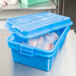 A Vollrath blue plastic food storage container with a raised lid.