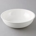 A white Cambro Camwear round ribbed bowl on a gray background.