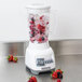 A white Proctor Silex blender filled with berries and ice.