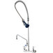A T&S wall mounted pre-rinse faucet with a hose and add-on faucet.