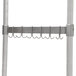 A stainless steel metal rack with hooks on it.