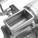A close up of a stainless steel Estella electric hard cheese grater.