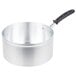 A silver Vollrath sauce pan with a black handle.