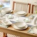 A set of square gray porcelain butter dishes displayed on a dining table.
