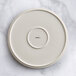 An Acopa Cape beige porcelain plate with a circular design on it.