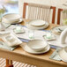 A rectangular gray porcelain platter displayed on a dining table set with matching dinnerware and decor.