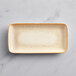 A rectangular white porcelain platter on a marble surface.