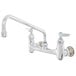 A T&S chrome wall mounted pantry faucet with two handles and a 12" swing nozzle.