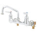 A chrome T&S wall mount pantry faucet with two handles.