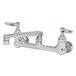 A T&S chrome wall mount pantry faucet with two handles and two faucets.