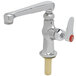 A silver T&S deck mount faucet with a red hot water index knob.