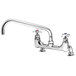 A T&S chrome wall mount faucet with 4 arm handles and a swing nozzle.