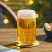 A close up of an Acopa Select rim tempered can glass of beer on a table.