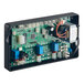 An electronic circuit board with various components, including connectors, capacitors, relays, and a transformer, mounted inside a black rectangular enclosure.
