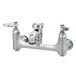 A T&S chrome wall mount mop sink faucet with two silver knobs.