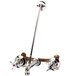 A chrome plated T&S wall mount mop sink faucet with 4 arm handles.