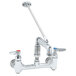 A T&S polished chrome wall mount service sink faucet with two handles and a hose.