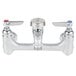 A T&S rough chrome wall mount service sink faucet with two silver knobs.