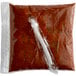 A white plastic bag of Advanced Food Products Premium Chili Sauce with a tube on it.