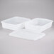 A white plastic Tablecraft freezer safe drain box with square holes.