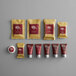 An 11-piece hotel amenity toiletries kit with various personal care items in gold and maroon packaging.