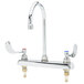 A chrome T&S deck mount faucet with 4" wrist action handles.