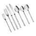 An assortment of stainless steel flatware including forks, knives, and spoons with textured handles.