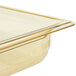 A Vollrath amber plastic food pan on a counter.