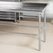 An Advance Tabco stainless steel sorting table with a stainless steel top.