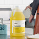 A 1-gallon container of Noble Sunbright lemon concentrated liquid dish soap.