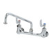 A chrome T&S wall mount faucet with two 4" wrist action handles.