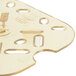 A close up of a Vollrath amber plastic drain tray with holes.