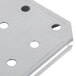 A close-up of a stainless steel Vollrath false bottom with holes in it.