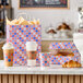 A patriotic USA print auto-popup window bakery box displayed with matching cups, a bag, and pastries.