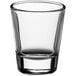 An Acopa clear shot glass on a white background.