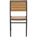 A BFM Seating Largo outdoor side chair with a black frame and synthetic teak wood back.