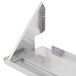 A stainless steel shelf with a metal bracket for a Bakers Pride countertop charbroiler.