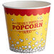 A yellow and red Carnival King popcorn bucket with white and red text.