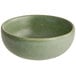 A small, round bowl with a matte sage green finish.