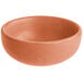 A small, round, terra cotta-colored bowl with a matte finish.