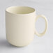 A plain, matte-finish, off-white mug with a rounded handle, shown on a light surface.