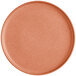 A round, terra cotta-colored plate with a matte finish and a slightly raised rim.