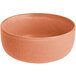 A round, terra cotta-colored bowl with a matte, slightly textured finish.