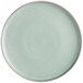 A round, matte, light blue plate with a smooth surface and slightly raised rim.